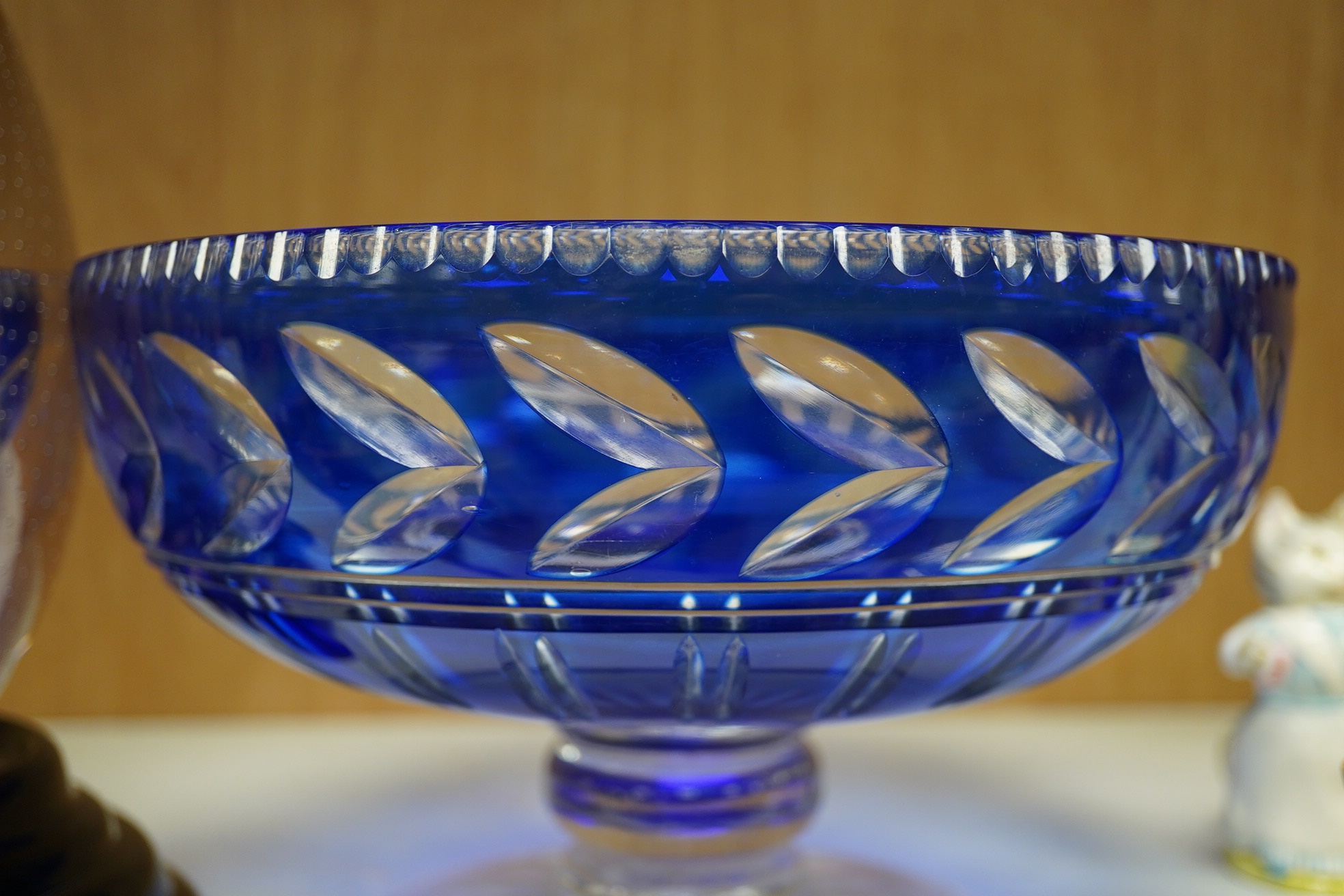 A Whitefriars amethyst ovoid vase on stand and a blue overlaid fruit bowl, vase on stand 20.5cm high. Condition - Whitefriars good, overlaid bowl interior base scratched